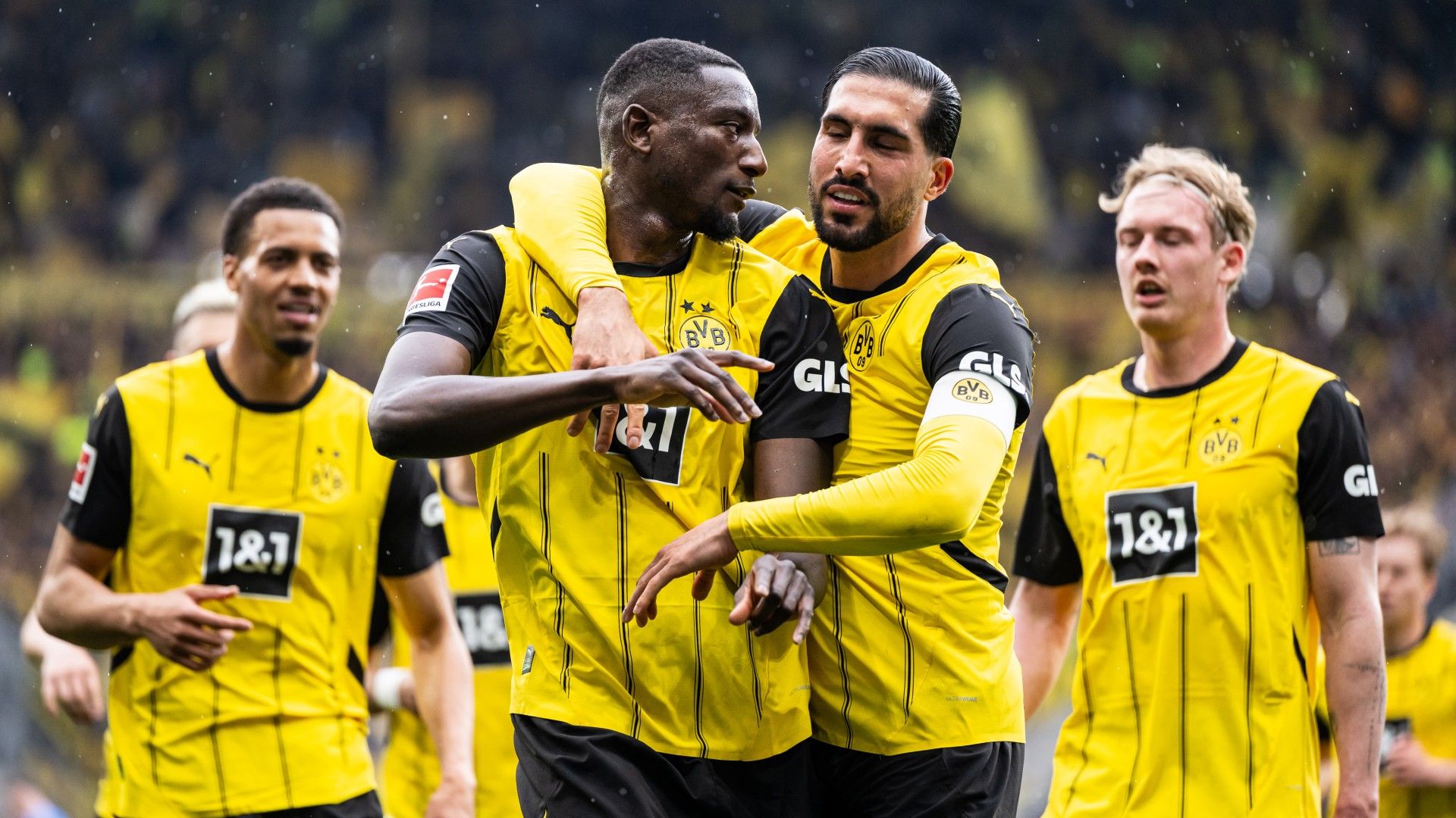 Serhou Guirassy (L) celebrates after scoring his team's first goal with Emre Can (R) of Dortmund