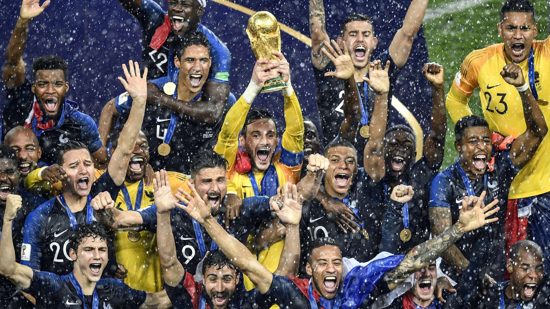 France's goalkeeper Hugo Lloris holds the trophy as he celebrates with teammates during the trophy ceremony at the end of the Russia 2018 World Cup