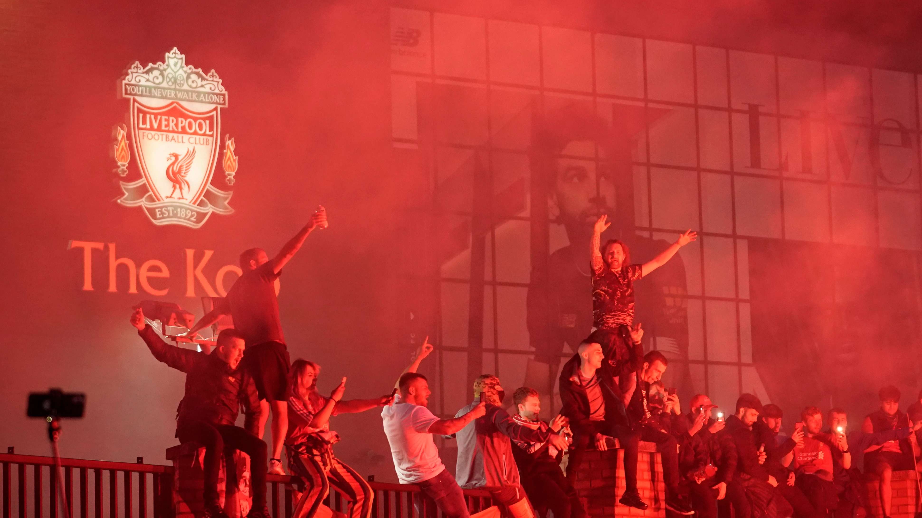 Fans Celebrate As Liverpool FC Lift The Premiership Trophy At Anfield