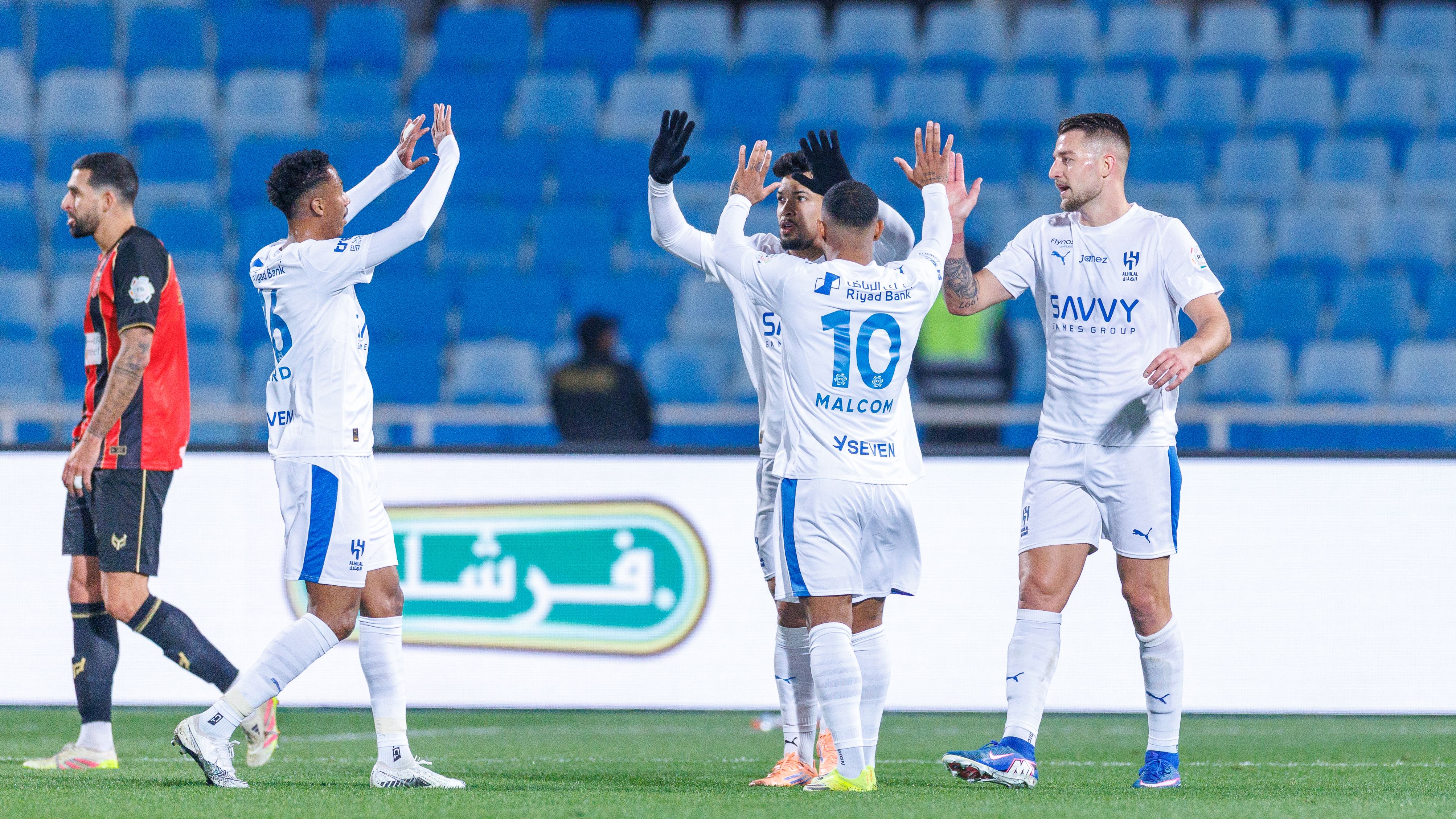 Al-Hilal players share jackets with children during a 1-1 Saudi Pro League draw in Riyadh