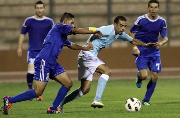 حسونة الشيخ (الفيصلي) ينطلق بالكرة ورامي جابر (ذات راس) يحاول ايقافه.