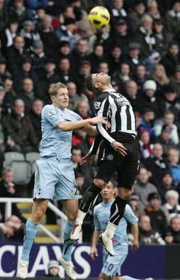 Newcastle's Leon Best (R) jumps