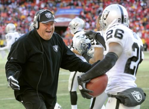 Oakland Raiders coach Tom Cable prepares with Stanford Routt
