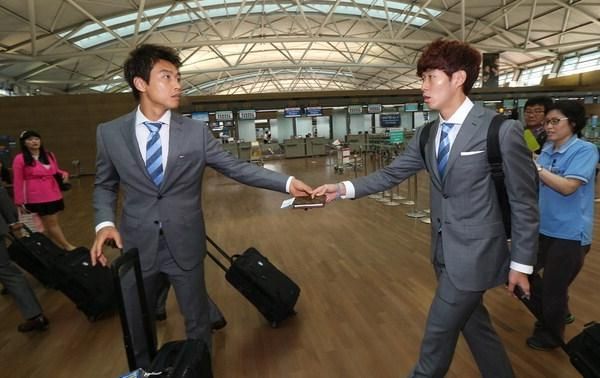 المهاجم لي دونج جوك (يسار) مع لاعب هامبورغ الالماني سون هيونج مين في مطار انتشيون