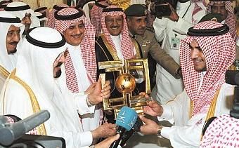 الملك عبدالله يسلم رئيس نادي الشباب كأس البطولة