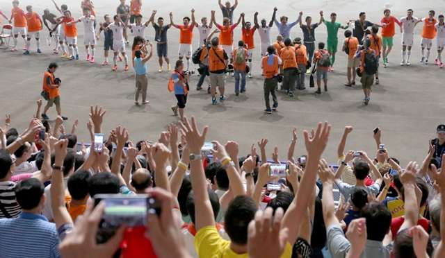 لاعبي منتخب هونغ كونغ يحتفلون مع الجمهور بعد كسب نقطة التعادل