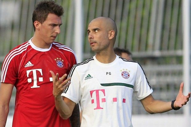 Bayern-Munich-s-head-coach-Pep-Guardiola-gestures-as-he-talks-with-his-player-Ma