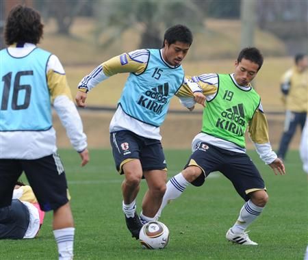 الظهير الأيسر يوتو ناغاتومو ( يمين ) في صراع كروي مع أوغاساوارا في تدريب اليوم