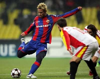 كيسوكي هوندا في صراع كروي مع مدافعي إشبيلية بدوري أبطال أوروبا