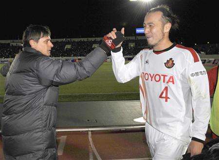 توليو تاناكا يتلقى التهاني من مدربه السيد ستويكوفيتش بعد تحقيق الإنتصار الأولى لناغويا بالموسم الجديد