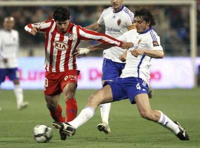 الايطالي كونتيني مدافع سرقسطة يبعد كرة أمام الارجنتيني أجويرو